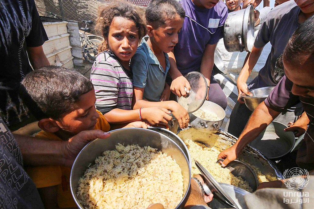 Displaced Palestinians lining up for food assistance