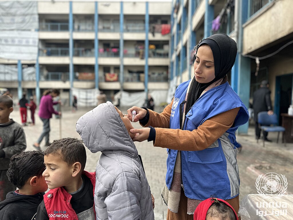 Child receiving vaccination in an UNRWA shelter in Gaza